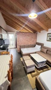 a living room with a bed and a couch at Apartments by Arbri 2 in Vlorë