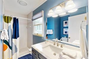 a blue bathroom with a sink and a mirror at Town of Bethany Beach --- 431 Collins St in Bethany Beach +11 photos