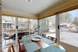 a screened in porch with a table and chairs at Town of Bethany Beach --- 431 Collins St in Bethany Beach