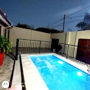 a large blue swimming pool in front of a building at Casa CNH 2 in Santiago del Estero