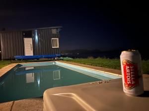a can of soda sitting on a table next to a swimming pool at Nogal in San Carlos de Bariloche +9 photos