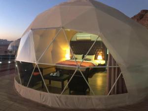a small tent with a bed inside of it at Rum gate camp Fares in Disah
