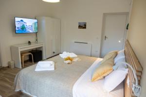 a bedroom with a bed with a tv on the wall at Casale Trifoglio in Morano Calabro