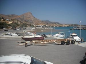 a boat on a trailer in a parking lot at Xenos Apartments in Keratokampos