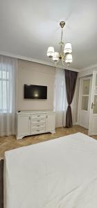 a bedroom with a bed and a flat screen tv at Sonne by BED-Stage in Braşov