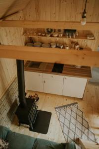 an overhead view of a kitchen with a wood stove at Domki pod Halą Krupową - Tiny House w Lesie in Sidzina