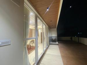 an empty hallway of a building with a large window at Dar E Noor in Hyderabad