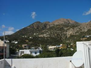 a view of a mountain with houses and buildings at Xenos Apartments in Keratokampos