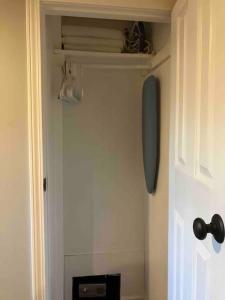 a room with a closet with a shelf and a door at Quaint Cottage - Kansas City Area in Kansas City