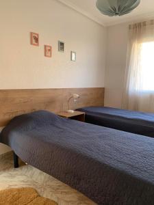a hotel room with two beds and a window at Cabo Cervera Sea View in Torrevieja