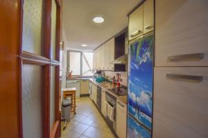 a kitchen with a refrigerator and a stove top oven at Sweetstaybykw Dean Llopez Stay in Santa Pola