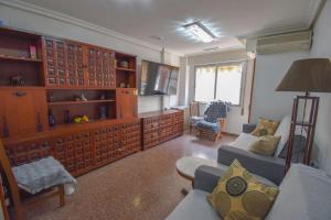 a living room with a couch and a table and a tv at Sweetstaybykw Dean Llopez Stay in Santa Pola