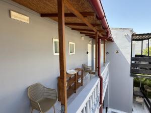 a balcony with a table and chairs on it at Dom Suites in Agioi Apostoli