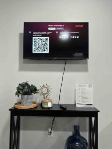 a black table with a tv on a wall at 5Bed 2Bath Near NYC, Parking, Laundry in Irvington