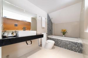 a bathroom with a sink and a toilet and a tub at Collection O Sunshine Garden Hotel - Near SECC in Ho Chi Minh City