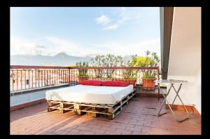 a bed sitting on top of a balcony with a window at Damazon room - Stanza con parcheggio privato in Viareggio