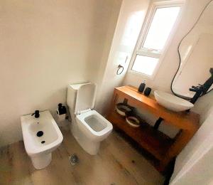 a bathroom with a sink and a toilet and a window at Ap 102 Disfruta este Alojamiento a Estrenar frente al Río in Islas López +19 photos