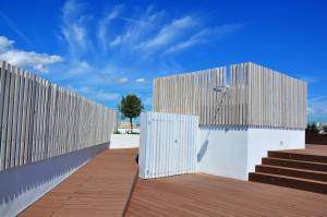 a white fence with wooden steps and a blue sky at Apartaments B-Llobet Sun & Confort in Ibiza Town