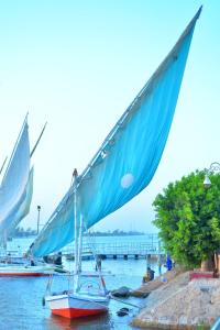 three boats are docked in the water near a pier at luxor in Luxor +12 photos