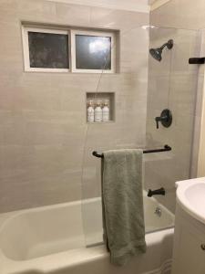 a bathroom with a shower and a bath tub with a towel at Cozy Hideaway and Hot Tub. Pet Friendly. in Eureka +6 photos