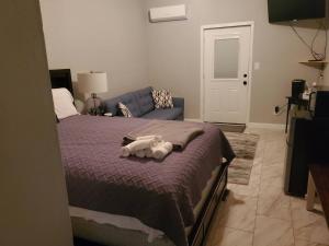 a bedroom with a bed with a stuffed animal on it at TigerMinnow Coles Lodge in Carrabelle