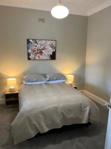 a bedroom with a large bed with two pillows at Beautiful comfortable cottage in Orange