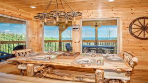 a dining room with a wooden table in a cabin at Wild Honey in Sevierville
