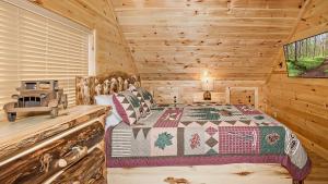 a bedroom with a bed in a log cabin at Wild Honey in Sevierville +27 photos