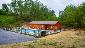 a log cabin with a pool in front of it at Wild Honey in Sevierville