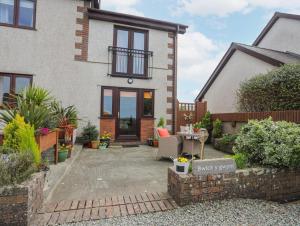 a detached house with a patio in front of it at Bwlch Y Gwynt Bach in Llangefni
