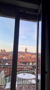 a balcony with a table and a view of a city at Fiore di langa in Alba +6 photos