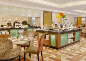 a restaurant with a counter with dishes on it at Richmonde Hotel Ortigas, Manila in Manila