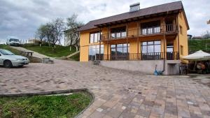 拉姆尼库沃尔恰Cabana Ene Strada Poienari nr 13 A的一栋房子前面停着一辆车