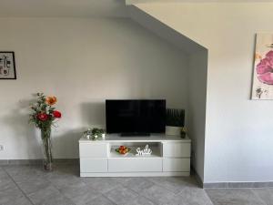 a flat screen tv sitting on a white cabinet at Dachgeschoss35 in Witten