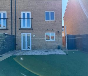 a brick house with a fence in front of it at MpaNjus - Double Rooms, Shared House in Bristol