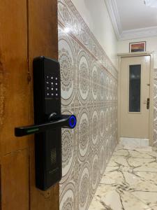 a phone is attached to a wall in a room at Airport Apartment 5 minutes walk, perfect for Early & Late Flights in Marrakech
