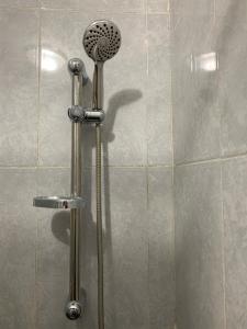 a shower with a shower head in a bathroom at Airport Apartment 5 minutes walk, perfect for Early & Late Flights in Marrakech +16 photos