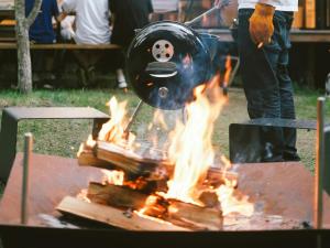 a person cooking over a fire in a grill at Karuizawa Mori Shiki VILLA - Vacation STAY 57076v in Kutsukake