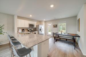 a kitchen with a counter top and a table at Family-Friendly, Pets Welcome Broken Arrow Gem! in Broken Arrow