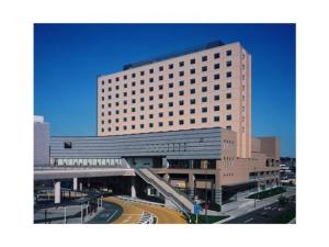 a large building with a road in front of it at Hotel Terrace the Garden Mito - Vacation STAY 75702v in Mito