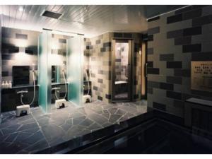 a bathroom with three urinals and stalls in a restroom at Hotel Terrace the Garden Mito - Vacation STAY 75702v in Mito