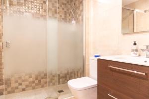 a bathroom with a shower and a toilet and a sink at Duplex apartment in Torremolinos