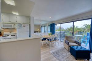 a kitchen and dining room with a view of the ocean at 217W 217 Whittley Ave in Avalon +26 photos