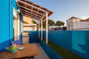 a blue house with a wooden table on the balcony at Y Quebedo - Boutique Apartments in Setúbal +91 photos