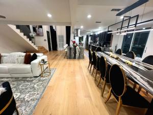 a living room with a white couch and chairs at Luxury Home w Pool, Open Kitchen, Poker Room & More in Dallas