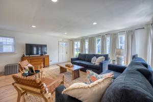 a living room with a blue couch and a tv at 221CL 221 Claressa Ave in Avalon
