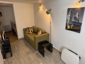 a living room with a couch and a lamp at Lisbon Secret & Graca Apartment in Lisbon