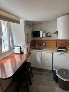 a kitchen with a wooden counter top in a room at Lisbon Secret & Graca Apartment in Lisbon