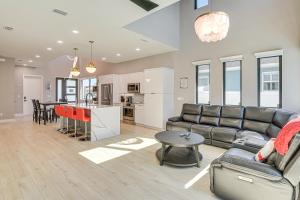 a living room with a couch and a table at Walk to Shore Modern Stunner in Ormond Beach! in Ormond Beach