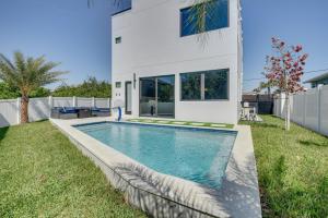 a swimming pool in the backyard of a house at Walk to Shore Modern Stunner in Ormond Beach! in Ormond Beach